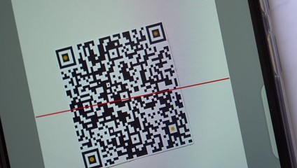 QR Code Scanner on the Smartphone close up. QR Code Reader App. QR code payment, commercial tracking, entertainment and transport ticketing, product and loyalty marketing and in-store product labeling