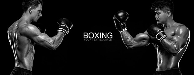 Boxers. Two male fighters in boxing gloves in combat racks on a black background. Fitness concept. Individual sports recreation.