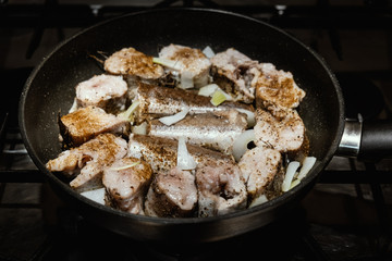 Fillet of sea white roasted fish in a frying pan. Appetizing and delicious seafood dish closeup. Cooking seafood, Pan-fried fish