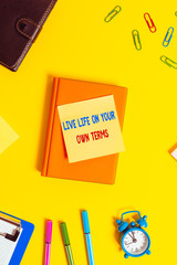 Naklejka na ściany i meble Word writing text Live Life On Your Own Terms. Business photo showcasing Give yourself guidelines for a good living Flat lay above table with copy space paper clips clock and pencils