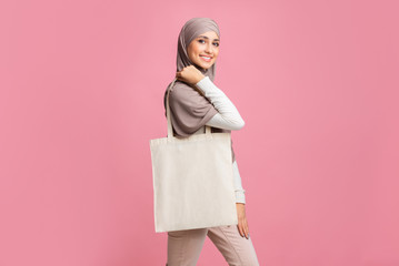 Arabic Lady In Hedscarf With Blank Eco Bag Over Pink Background
