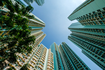 Fototapeta na wymiar looking up on high-rise apartment building, residential building facade, hongkong