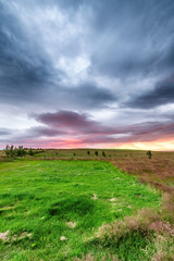 Sunset in Iceland. Countryside meadows and red sky