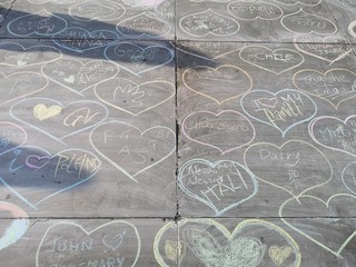 Love messages and hearts drawn on the concrete pavement