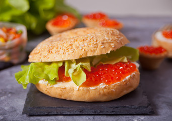 Fresh red caviar on bread. Sandwiches with red caviar and tartles with red caviar. Delicatessen. Gourmet food