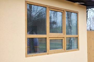 Installed metal-plastic window in a wooden house.