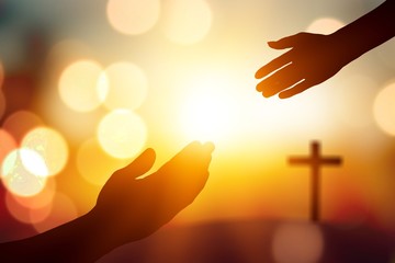 Silhouette hand  on Christmas sunset background, Jesus reaching concept