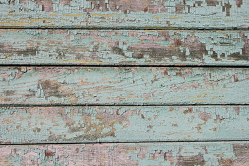 Fototapeta na wymiar Old shabby wooden planks with cracked color paint.