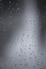 Rain water drops  on clear window.  Natural Pattern of raindrops. Autumn  nature  background..
