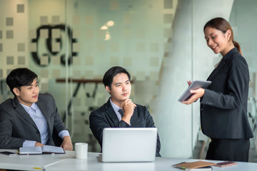 Group of modern business people are talking and smiling at the meeting. Asian business groups discussed investment and business planning at the meeting.