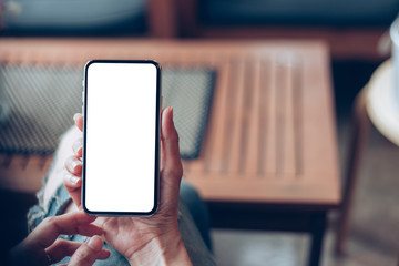 Mockup image blank white screen cell phone.man hand holding texting using mobile sitting at coffee shop.background empty space for advertise text.people contact marketing business,technology 
