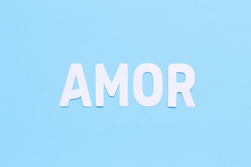 Fototapeta premium Word AMOR on a light blue background