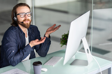 Young man call center agent speaking with costumer