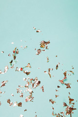Golden tinsel on pastel green background with copy space.