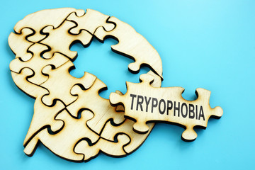 Word Trypophobia on the wooden puzzle with brain shape.