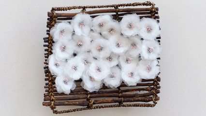 Handmade white flowers made out of floral cloth or blossom fabric. These handicraft floral white with petal pistil are great for DIY project and handicraft collections.