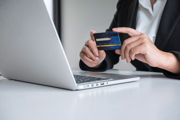 Business woman consumer holding credit card and typing on laptop for online shopping and payment make a purchase on the Internet, Online payment, networking and buy product technology