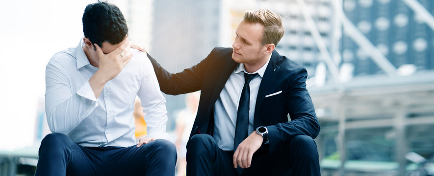 Two Caucasian businessmen sit in city. Unemployment concerns And work unsuccessfully as the employer wants.