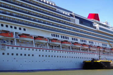 Huge cruiseship or cruise ship liner in port at terminal in Manhattan New York with skyline and...