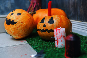 Halloween background: decorated pumpkins and bloodied candles