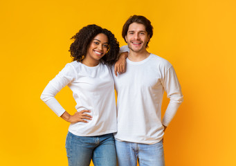 Portrait of happy interracial couple hugging and posing to camera