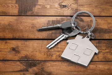 House metal keys on wooden floor background
