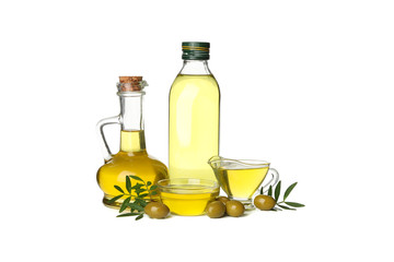 Glass bottle, jug and bowls with olive oil isolated on white background