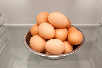 bowl of eggs from hen or chicken in a fridge