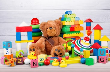 Many colorful toys collection on wooden desk