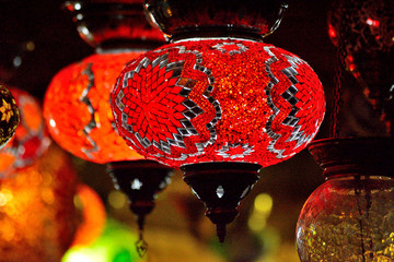 Traditional turkish lanterns lit up after dak hanging next to each other © georgezsiga