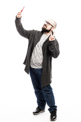 A bald man with glasses and a beard takes a selfie on the phone. Full height. Isolated on a white background. Vertical.