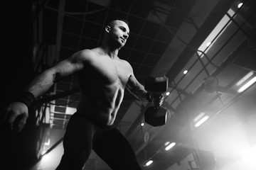Fototapeta na wymiar Young sportsman weightlifting while working out in health club.
