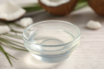 Coconut oil on white wooden table, closeup