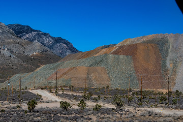 Multiple rock types in aggregate pile on mountain side