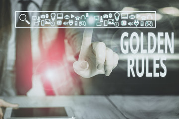 Writing note showing Golden Rules. Business concept for basic principle that should always follow to ensure success Woman wear formal work suit presenting presentation using smart device