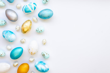 Happy Easter card concept. Border Frame with gold and blue speckled easter eggs with copy space for text isolated on white background. Top view