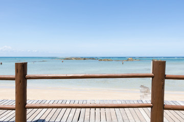 View of deserted beach and wooden deck. Blue Ocean Background. Brazil. Bahia. Morro de Sao Paulo.