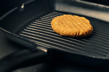 vegan burger cooking on the grill