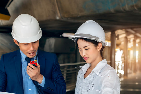 Handsome Asian business engineer of manager woman smiling and talking about success work with partners.