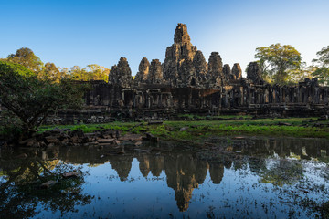 Fototapeta na wymiar The reflection on the water of Bayon temple in the morning light, Angkor Thom, Siem reap, Cambodia