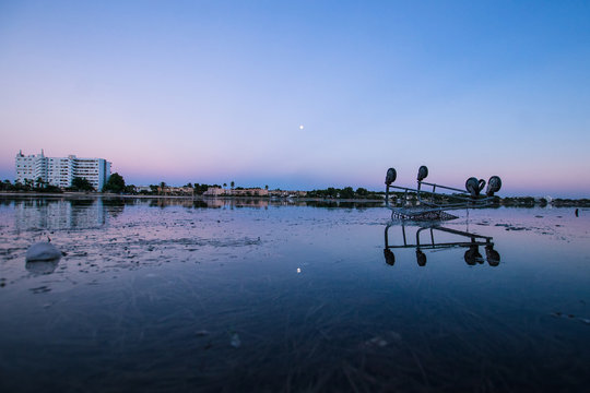 Picturesque scenery of idyllic on tranquil lake under amazing colorful sky during sunset against harmful effects of human activity on environment