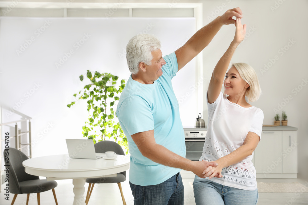 Sticker Happy mature couple dancing together in kitchen