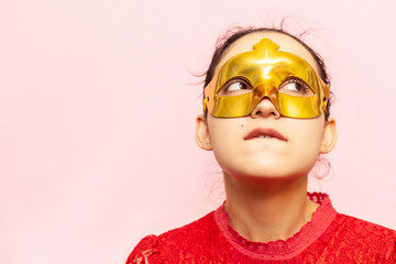 Portrait of beautiful woman in evening dress and golden masquerade mask. Valentines day, Carnival, Festive Ball, Birthday celebration concept. Facial expressions of young female