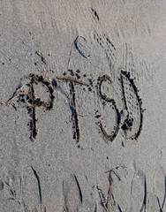 ptsd text on a beach sand