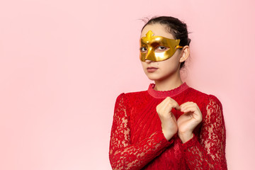 Portrait of beautiful woman in evening dress and golden masquerade mask. Valentines day, Carnival, Festive Ball, Birthday celebration concept. Facial expressions of young female