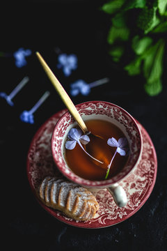 Traditional tea with mint and assorted homedade Arab sweets on dark background. Ramadan. Islamic. Halal