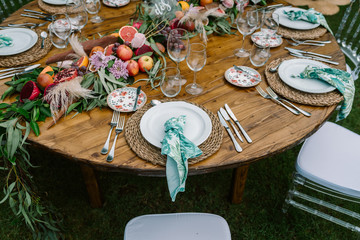 Wedding table decoration in rustic style placed outdoors