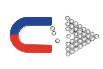 Magnet attracting metal nuts on white background, top view