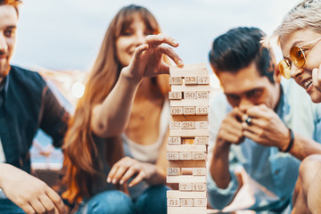 The company of young people playing jenga