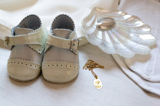 Shoes, Shell And White Baby Suit, With A Gold Medal